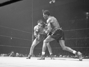 In this Feb. 23, 1945, file photo, Jake LaMotta, left, of the Bronx borough of New York, and Ray Robinson of the Harlem section of New York, fight at Madison Square Garden in New York. Robinson won the fight on a decision. (AP Photo/Matty Zimmerman, File)