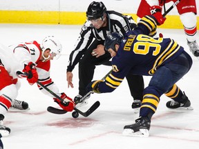 Buffalo Sabres' Ryan O'Reilly and Carolina Hurricanes' Lucas Wallmark take a faceoff during a pre-season NHL game on Sept. 18, 2017, in Buffalo, N.Y. (AP Photo/Jeffrey T. Barnes)