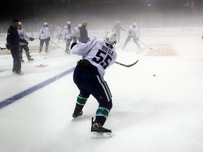 In this Tuesday, Sept. 19, 2017 photo, the Vancouver Canucks' players practice at the foggy Mercedes-Benz Arena in Shanghai, China. (AP Photo)