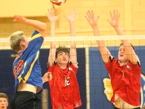 Oakridge's Luke Blissett who played for the National team's U17 squad this summer hits into the block of Medway's Rory Welch and Lucas Bycraft during their season opening match at Oakridge on Wednesday September 20, 2017. The Oaks won 25-16, 27-25 and 25-17 as the Cowboys showed they were not going to go quietly this season. Mike Hensen/The London Free Press/Postmedia Network