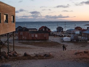 Residents walk down the hill to their home in the town of Gjoa Haven, Nunavut, on Friday September 1, 2017. THE CANADIAN PRESS/Jason Franson