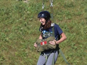 TIM MEEKS/THE INTELLIGENCER
OJ 95.5 and Cool 100 on-air personality Emily Quesnelle laughs while taking a leap of faith off the Mock Jump Tower at 8 Wing Trenton Thursday. Media Day was held Thursday for the annual Government of Canada Workplace Charitable Campaign Community Fair set for Friday, Sept. 29 at 8 Wing where the public is welcome to participate in a wide variety of activities.