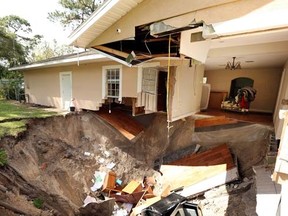 A home at 222 West Kelly Park Road in Apopka, Fla., is being swallowed by a sinkhole on Tuesday, Sept. 19, 2017. Days later, a second sinkhole has opened up in the neighbourhood about a half-mile (0.8 kilometres) away. (Stephen M. Dowell /Orlando Sentinel via AP)