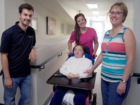 Joey Mudde, pastor at Compass Community Church (left), stands next to the building’s new accessible front entrance alongside Shannin Allen, a personal support worker with the Stepping Stone, Brittany Deyle, a Stepping Stone client, and Sue Reaume, the Stepping Stone’s co-ordinator. Compass, Stepping Stone, and the Glen Cairn Resource Centre, all offer programming at 345 Pond Mills Rd. and recently received a grant to complete renovations to make their building more accessible. (CHRIS MONTANINI\LONDONER\POSTMEDIA NETWORK)