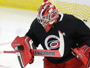 Carolina Hurricanes goalie Scott Darling blocks a shot during the NHL hockey team's training camp in Raleigh, N.C., on Sept. 15, 2017. (AP Photo/Gerry Broome)