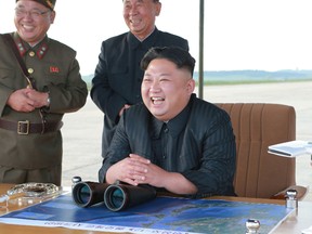 In this undated file photo distributed on Saturday, Sept. 16, 2017, by the North Korean government, North Korean leader Kim Jong Un, center, attends what was said to be the test launch of an intermediate range Hwasong-12 missile at an undisclosed location in North Korea. Kim is calling President Donald Trump "deranged" and says in a statement carried by the state news agency that he will "pay dearly" for his threats. The statement, carried by North's official Korean Central News Agency, responds to Trump's combative speech at the U.N. General Assembly on Tuesday, Sept. 19. (Korean Central News Agency/Korea News Service via AP, File)