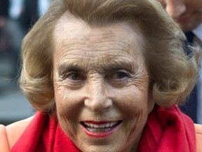 In this March 29, 2012 file photo, L'Oreal heiress Liliane Bettencourt leaves the L'Oreal-UNESCO prize for the women in science, in Paris, France. L'Oreal cosmetics heiress Liliane Bettencourt has died at the age of 94 at her home, her family announced. (AP Photo/Thibault Camus, File)