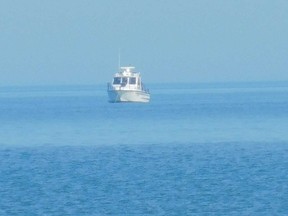 Rescuers continued searching Friday for a man who's been missing since a small plane crashed into Lake Huron late Wednesday near Goderich. The body of the other person on board, a woman, has already been found. (Kathleen Smith/Postmedia Network)