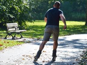 Rob Walsh of Thorndale rollerblades in Gibbons Park Friday as London experiences record temperatures. (MORRIS LAMONT, The London Free Press)