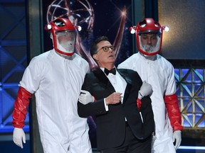 Host Stephen Colbert is drug offstage during the 69th Emmy Awards at the Microsoft Theatre on September 17, 2017 in Los Angeles, California.  (FREDERIC J. BROWN/AFP/Getty Images)