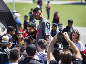 Raptors 905 Bruno Caboclo poses with a fan as the team celebrates winning the 2017 NBA D-League championship at Celebration Square in Mississauga, Ont. on April 28, 2017. (Ernest Doroszuk/Toronto Sun/Postmedia Network)