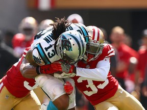 Kelvin Benjamin of the Carolina Panthers catches the ball while covered by Rashard Robinson and Eric Reidof the San Francisco 49ers at Levi's Stadium on Sept. 10, 2017 in Santa Clara, California. (Ezra Shaw/Getty Images)