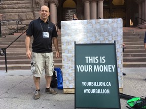 Antony Niro, of youbillion.ca, carted a skid with $1 billion in fake cash out to the front of the Old City Hall courthouse during the trial for two senior Liberal political staffers accused of deleting emails related to the gas plants scandal on Friday, Sept. 22, 2017. (Antonella Artuso/Toronto Sun)