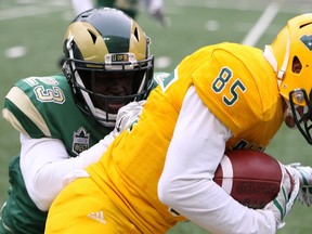 University of Alberta Golden Bears receiver Nathan Rowe, right is tackled by University of Regina Rams defensive back Polis Koko at New Mosaic Stadium in Regina, Sask., on Sept. 16, 2017.