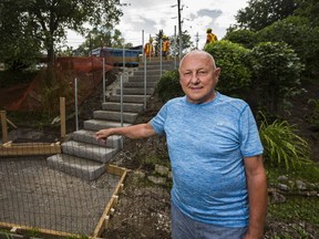 Resident Adi Astl poses for a photo as City of Toronto workers build a staircase at Tom Riley Park on Bloor St. W., west of Islington Ave. in Toronto, Ont. on Thursday July 27, 2017. Astl had earlier built a staircase in the same spot for $550. (Ernest Doroszuk/Toronto Sun)