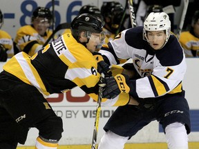 Kingston Frontenacs defenceman Jacob Paquette knocks into Erie Otters' Christian Girhiny during Ontario Hockey League action at the Rogers K-Rock Centre on Friday. (Ian MacAlpine /The Whig-Standard)