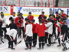 Head coach Guy Boucher talks to his Ottawa Senators team after the morning skate at Canadian Tire Centre in Ottawa on Sept. 22, 2017. (Jean Levac/Postmedia)