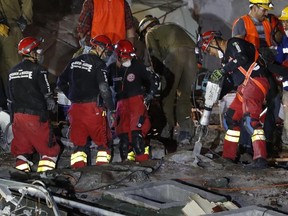 A rescue worker uses a jackhammer to break up concrete at the site of an office building felled by a 7.1-magnitude earthquake, in the search for people who are believed to be trapped inside at the corner of Alvaro Obregon and Yucatan streets in Mexico City on Friday, Sept. 22, 2017. (Eduardo Verdugo/AP Photo)