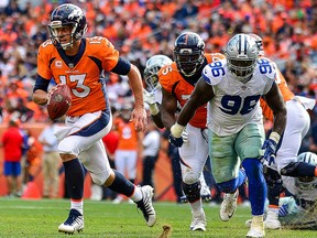 Denver Broncos' Quarterback Trevor Siemian scrambles against the Dallas Cowboys in the third quarter of a game at Sports Authority Field at Mile High on Sept.17, 2017 in Denver, Colo. (Dustin Bradford/Getty Images)