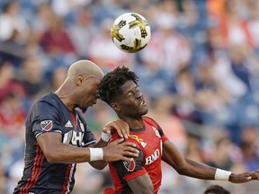 New England Revolution forward Juan Agudelo, left, and Toronto FC forward Tosaint Ricketts bang heads as they compete for control of the ball. (AP)