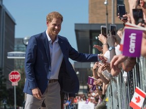 Prince Harry greets a waiting crowd as he visits The Centre for Addiction and Mental Health in Toronto on Saturday, September 23, 2017. (Chris Young/THE CANADIAN PRESS)