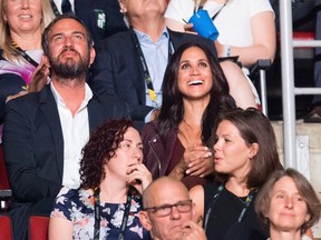 Meghan Markle, top right, attends the Invictus Games Opening Ceremonies in Toronto on Saturday, Sept. 23, 2017, a few rows apart from her boyfriend, Britain's Prince Harry. Markle lives in Toronto, but hadn't appeared with Harry since he arrived in the city. (Nathan Denette/The Canadian Press via AP)