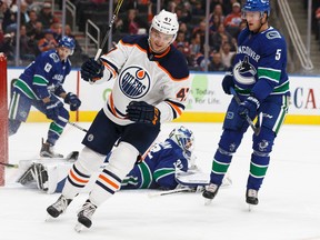 Edmonton's Keegan Lowe (47) scores on Vancouver's goaltender Richard Bachman (32) which was later ruled goaltender interference during a preseason NHL game between the Edmonton Oilers and the Vancouver Canucks at Rogers Place in Edmonton, Alberta on Friday, September 22, 2017. Ian Kucerak / Postmedia