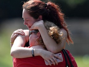 Kaitlyn Adams, a member of the Burnette Chapel Church of Christ, hugs another church member at the scene after a deadly shooting at the church on Sunday, Sept. 24, 2017, in Antioch, Tenn. (Andrew Nelles/The Tennessean via AP)