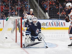 Winnipeg Jets' goalie Michael Hutchinson (34) makes the save on Edmonton Oilers' Patrick Maroon (19) during second period pre-season NHL action in Edmonton, Alta., on Saturday September 23, 2017. THE CANADIAN PRESS/Jason Franson