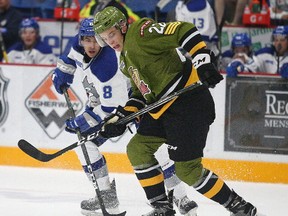 Conor Ali of the Sudbury Wolves battles for the puck with Brady Lyle of the North Bay Battalion during OHL action in Sudbury, Sunday. Lyle notched his first goal of the season, part of a five-goal, third-period rally to beat the Wolves 6-5. Gino Donato/The Sudbury Star/Postmedia Network