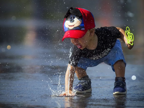 Ottawa set heat and humidity records Sunday and it's going to stay hot Monday and Tuesday. One-year-old Nayden cooled off at Lansdowne's water plaza Sunday September 24, 2017. ASHLEY FRASER / POSTMEDIA