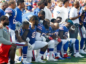Buffalo Bills players take a knee during the playing of the national anthem prior to an NFL game against the Denver Broncos in Orchard Park, N.Y., on  Sunday, Sept. 24, 2017. (Jeffrey T. Barnes/AP Photo)