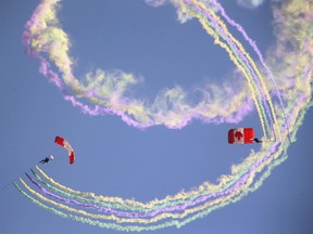 The Canadian Armed Forces parachute team, the SkyHawks perform the ?candy cane? with smoke grenades. (MIKE HENSEN, The London Free Press)