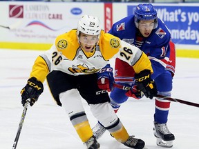 Sarnia Sting's Franco Sproviero, left, battles Kitchener Rangers' Giovanni Vallati in the first period at Progressive Auto Sales Arena in Sarnia, Ont., on Saturday, Sept. 23, 2017. (Mark Malone/Postmedia Network)