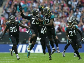 Jaguars cornerback Jalen Ramsey (centre left) celebrates after intercepting a pass with cornerback Aaron Colvin (22) during the second half of NFL action against the Ravens at Wembley Stadium in London on Sunday Sept. 24, 2017. (Tim Ireland/AP Photo)