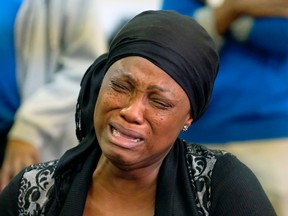 A congregation member grieves during a church service at Solid Rock Church International in Edmonton on Sunday, September 24, 2017. Three women from the church congregation died and a fourth was transported to hospital in Edmonton after a stolen heavy-duty, flat-deck truck collided with a minivan on Highway 16 about five kilometres east of Lloydminster. The wife of the church pastor was one of the victims killed in the crash. PHOTO BY LARRY WONG