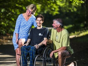 Joshua Noronha, who is paralyzed after a recent trampoline accident, is seen outside of Toronto's Lyndhurst Centre on Saturday, September 23, 2017 with his  mother Leslie Pocklington and her husband Chris Dopp. (Ernest Doroszuk/Toronto Sun)