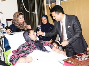 In this Monday, Sept.11, 2017 photo released by Burjeel Hospital, Eman Abdul Atti, an Egyptian once known as "the world's heaviest woman" receives a piece of cake from Dr. Shamsheer Vayalil during her 37th birthday party at the Burjeel Hospital in Abu Dhabi, United Arab Emirates. Doctors said Monday, Sept. 25, 2017 that Abdul Atti has died in a hospital in the United Arab Emirates. She was 37. (Burjeel Hospital via AP)