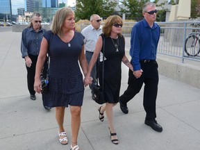 Deb Abrams, mother of Adam Kargus (centre) and her partner Ken Abrams (far right) enter the London courthouse on Monday with loved ones for the trial of Anthony George. George is charged with second-degree murder in the beating death of her son, Adam Kargus, while the two were cellmates in London?s troubled provincial jail, the Elgin-Middlesex Detention Centre. (MORRIS LAMONT, The London Free Press)