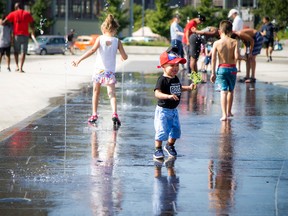 Ottawa set heat and humidity records Sunday and it’s going to stay hot Monday and Tuesday. One-year-old Nayden cooled off at Lansdowne's water plaza Sunday September 24, 2017.   Ashley Fraser/Postmedia