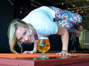 Meggie Ashton helps teach a yoga class that runs every other Wednesday at the Railway City Brewing Co., a northeast St. Thomas brewery. Beer and yoga is exactly what it sounds like: have a beer with friends, with a twist. (Louis Pin/Times-Journal)