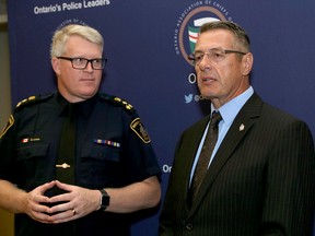 Bryan Larkin, left, Waterloo Region Police chief and president of the Ontario Association of Police Chiefs, and Kingston Police Chief Gilles Larochelle at an association meeting at the Four Points by Sheraton in Kingston on Monday.  I(an MacAlpine/The Whig-Standard)