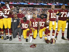 Washington Redskins players during the the national anthem before the game against the Oakland Raiders at FedExField on September 4, 2017 in Landover, Maryland.