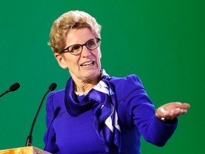 Ontario Premier Kathleen Wynne, delivers her speech during a signing ceremony at the United Nations Climate Change Conference Monday, Dec. 7, 2015 in Le Bourget, north of Paris. (AP Photo/Christophe Ena)