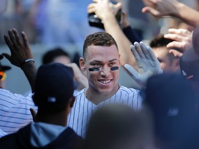 New York Yankees' Aaron Judge greets teammates in the dugout after hitting a home run during an MLB game against the Kansas City Royals at Yankee Stadium on Sept. 25, 2017. (AP Photo/Seth Wenig)
