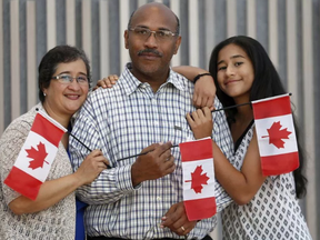 Aida Castillo, Duane Omeir and Melissa Omeir (13)  get a photo taken after becoming Canadian citizens an citizenship ceremony at the National Arts Centre (NAC) in Ottawa Ontario Monday Sept 25, 2017.  TONY CALDWELLL, POSTMEDIA