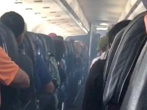 This frame from mobile phone video shows smoke inside an Allegiant Air jet after it landed at Fresno Yosemite International Airport in California’s Central Valley, Monday, Sept. 25, 2017. (Estevan Moreno via AP)