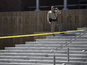 Police investigate a crime scene in front of the Regional Justice Center courthouse, Monday, Sept. 25, 2017, in Las Vegas. (AP Photo/John Locher)