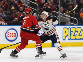 Edmonton's Connor McDavid (97) battles Carolina's Noah Hanifin (5) during the first period of a preseason NHL game between the Edmonton Oilers and the Carolina Hurricanes at Rogers Place in Edmonton, Alberta on Monday, September 25, 2017.