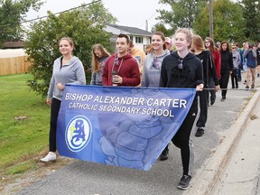 Students and staff at Bishop Alexander Carter Catholic Secondary School participate in their annual fundraising memorial walk in memory of Mackenzie Rooney and Dennis Deschaine in Hanmer, Ont. on Thursday September 29, 2016. John Lappa/Sudbury Star/Postmedia Network